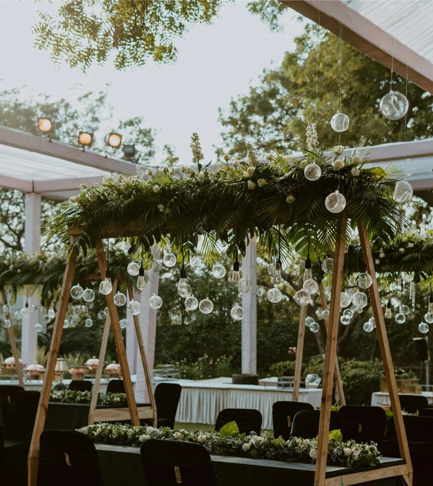 An elegant outdoor wedding design with abundant greenery